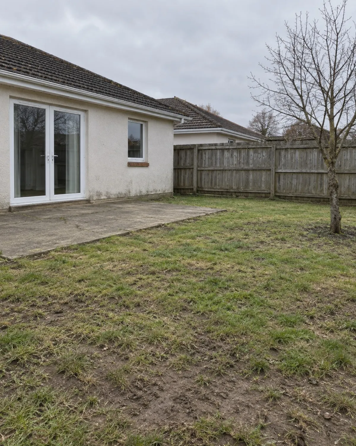 A plain lawn and patio before redesign